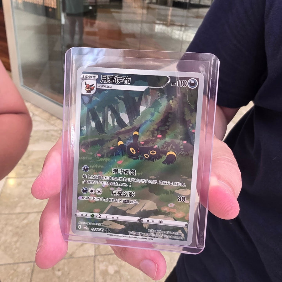 A collector holding a Pokémon card protected in a hard case at Cards2Go